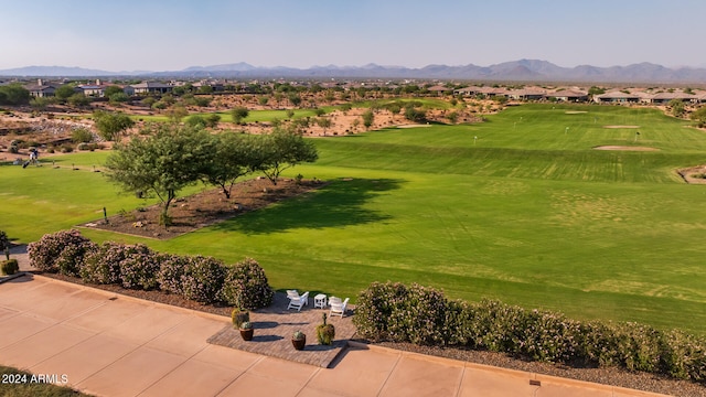 view of community featuring a lawn and a mountain view