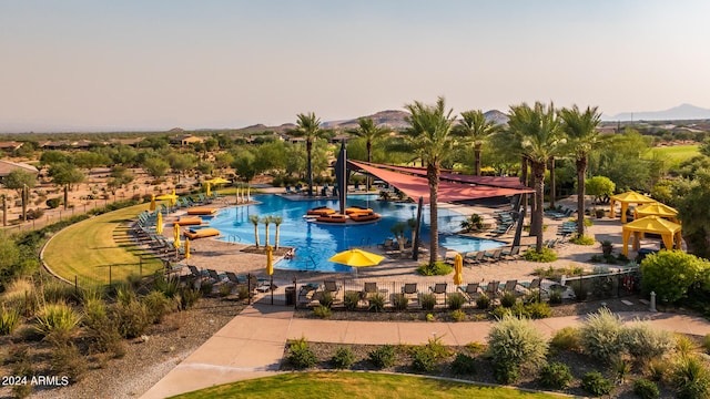 view of swimming pool with a mountain view