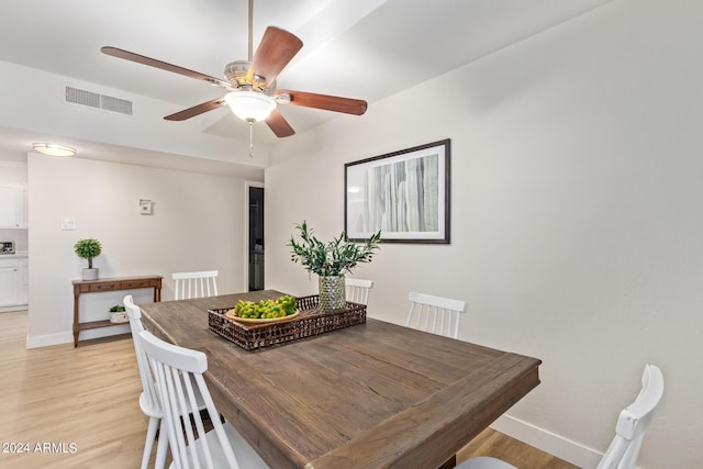 dining area featuring light wood-type flooring and ceiling fan