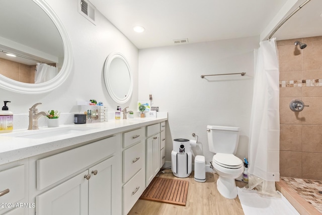 bathroom with vanity, hardwood / wood-style flooring, a shower with shower curtain, and toilet