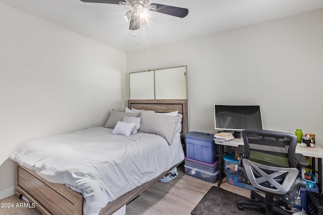 bedroom with light wood-type flooring and ceiling fan