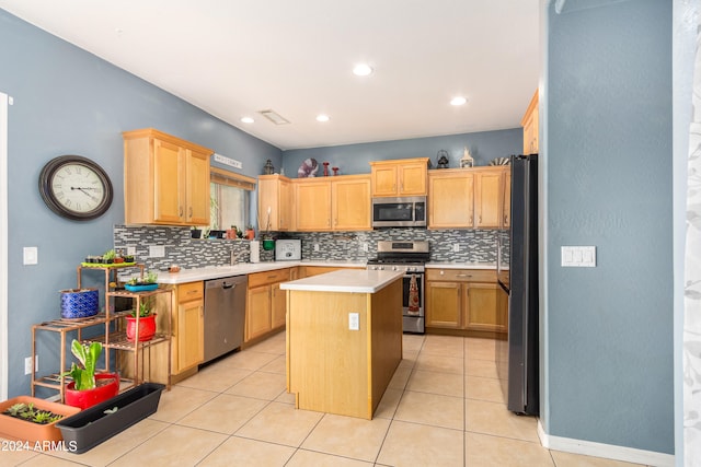 kitchen with light tile patterned flooring, stainless steel appliances, tasteful backsplash, and a kitchen island