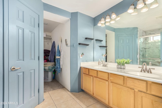 bathroom featuring tile patterned flooring, walk in shower, and vanity