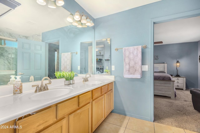 bathroom featuring vanity, a shower with shower door, and tile patterned flooring