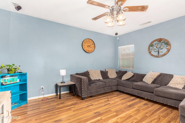 living room with wood-type flooring and ceiling fan