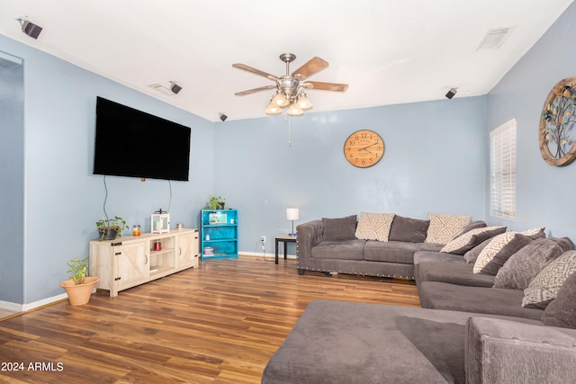 living room with wood-type flooring and ceiling fan