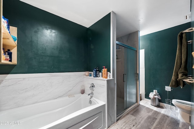 bathroom featuring independent shower and bath, hardwood / wood-style floors, and toilet