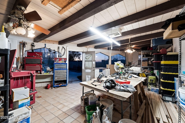 interior space featuring beam ceiling, a workshop area, ceiling fan, and light tile patterned flooring