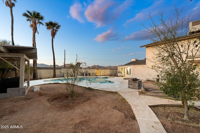 view of pool featuring a water slide and a patio