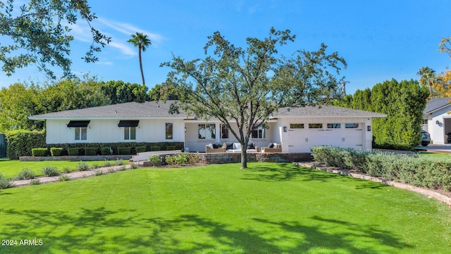 ranch-style home with a garage and a front yard