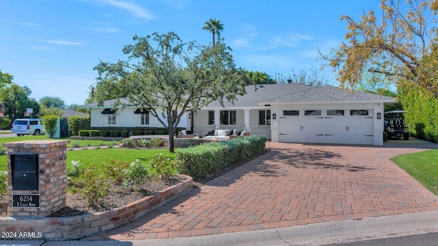 view of front of property featuring a garage and a front yard