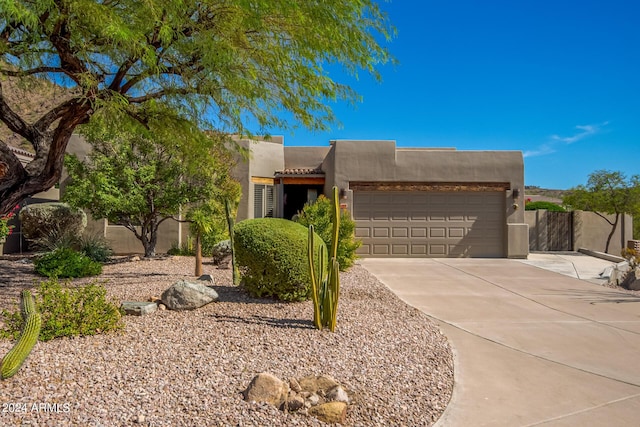 pueblo-style home with a garage