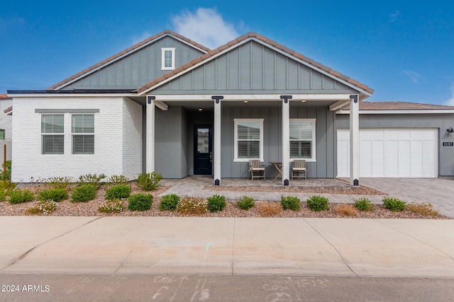 view of front of home with a porch and a garage