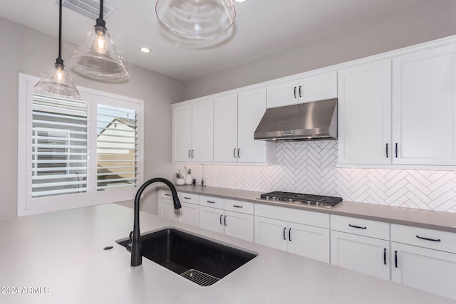 kitchen with white cabinetry and tasteful backsplash