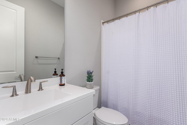 bathroom featuring toilet and vanity