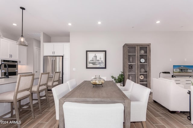 dining room featuring sink and hardwood / wood-style floors