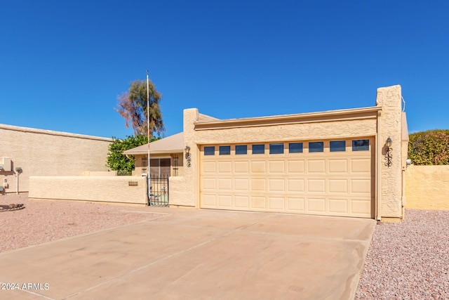 pueblo revival-style home with a garage