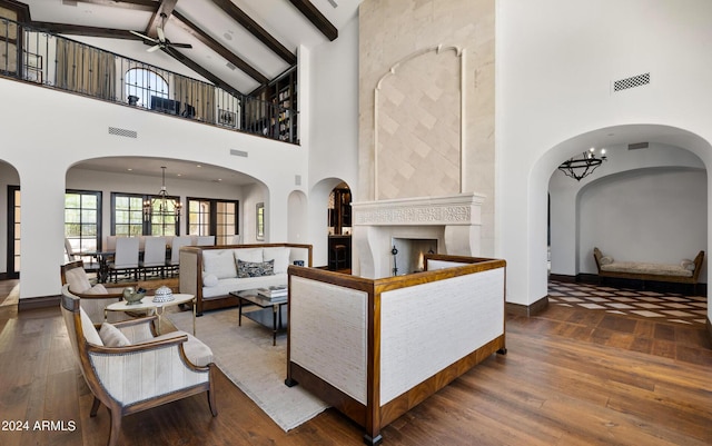 living room with hardwood / wood-style flooring, a fireplace, visible vents, and beam ceiling