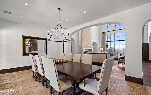 dining room featuring baseboards, visible vents, wood finished floors, a notable chandelier, and recessed lighting