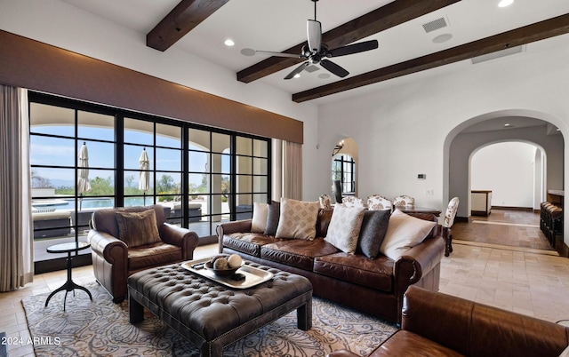 living area featuring arched walkways, beam ceiling, visible vents, and recessed lighting