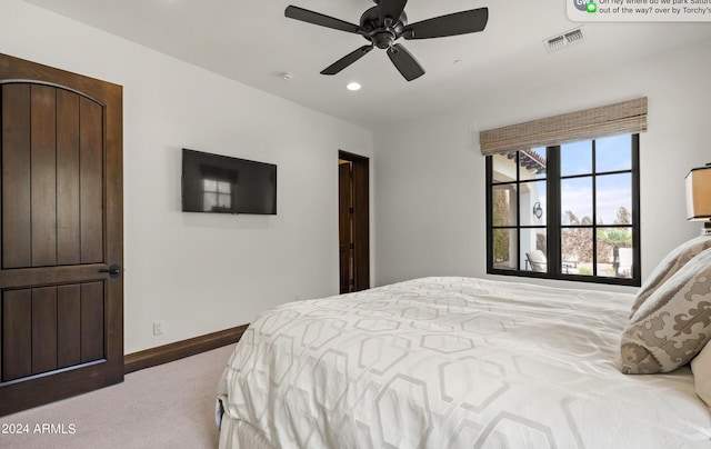 bedroom featuring carpet floors, baseboards, visible vents, and a ceiling fan