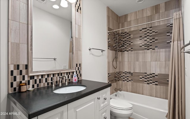 full bathroom featuring tasteful backsplash, shower / bathtub combination with curtain, toilet, and vanity