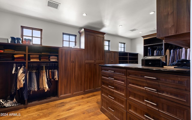 spacious closet featuring light wood-style flooring and visible vents