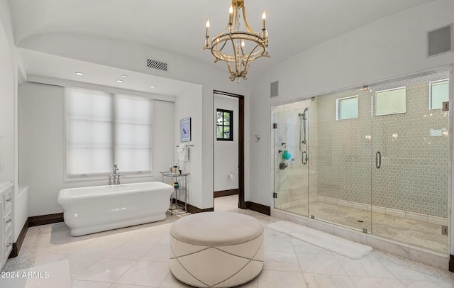 bathroom with a freestanding bath, a stall shower, visible vents, and baseboards