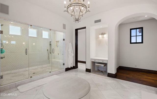 full bath featuring a stall shower, visible vents, baseboards, and a chandelier