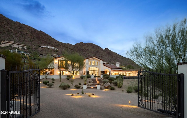 view of gate featuring a fenced front yard and a mountain view