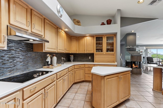 kitchen with light tile patterned flooring, a sink, black electric cooktop, and under cabinet range hood