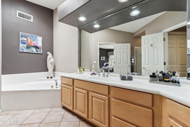 ensuite bathroom with visible vents, connected bathroom, tile patterned floors, vanity, and a bath