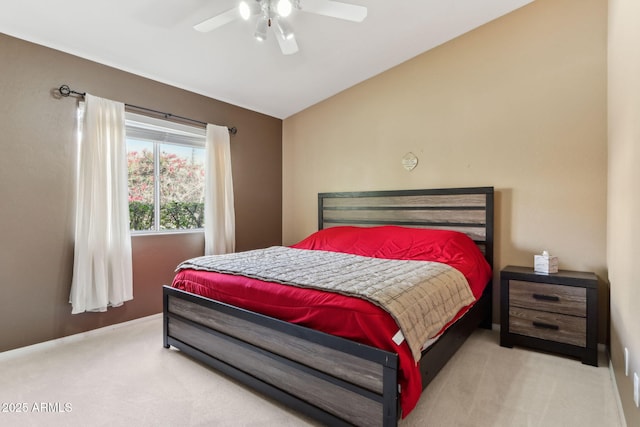 carpeted bedroom with a ceiling fan and lofted ceiling