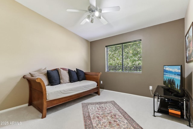 carpeted living area with lofted ceiling, a ceiling fan, and baseboards