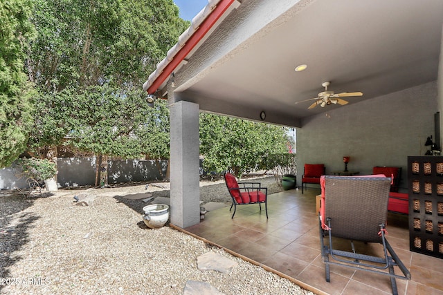 view of patio / terrace featuring ceiling fan and fence