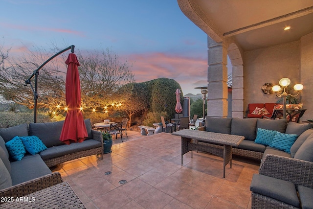 patio terrace at dusk with outdoor dining area and outdoor lounge area