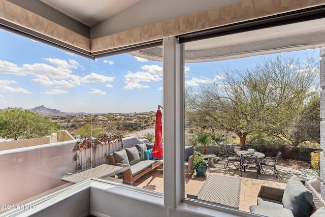 view of patio featuring outdoor dining area, outdoor lounge area, and a mountain view