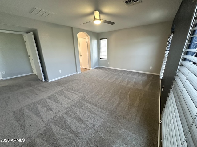 8514 S 49th Dr, Laveen, AZ 85339 - unfurnished bedroom featuring arched walkways, carpet, and baseboards