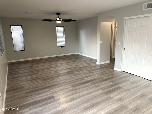 8514 S 49th Dr, Laveen, AZ 85339 - spare room with arched walkways, ceiling fan, plenty of natural light, and baseboards