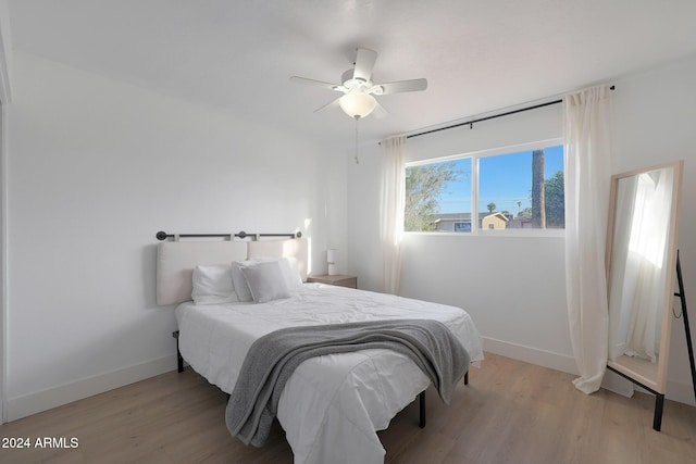 bedroom with ceiling fan and light wood-type flooring