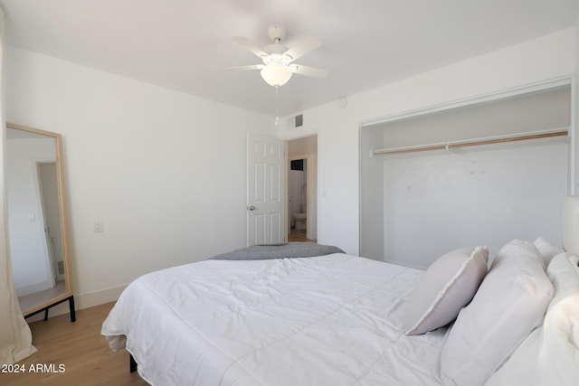 bedroom with ceiling fan, a closet, and light hardwood / wood-style floors