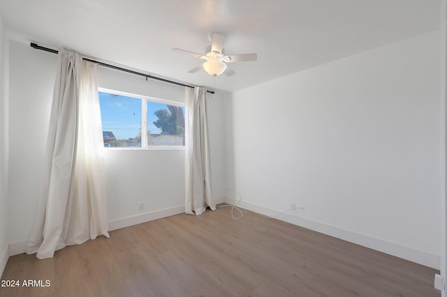 unfurnished room with ceiling fan and light hardwood / wood-style floors