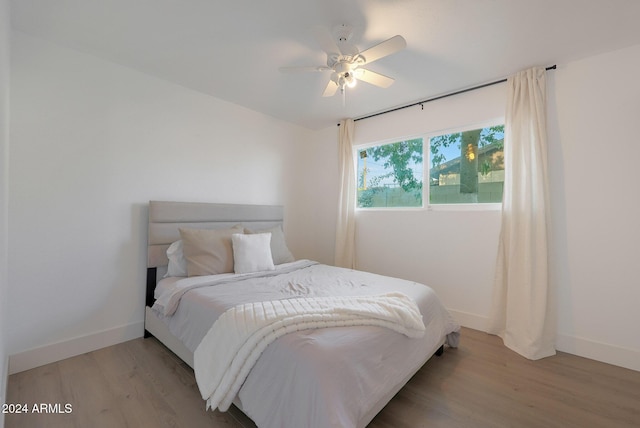 bedroom with ceiling fan and wood-type flooring