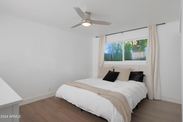 bedroom with ceiling fan and hardwood / wood-style flooring