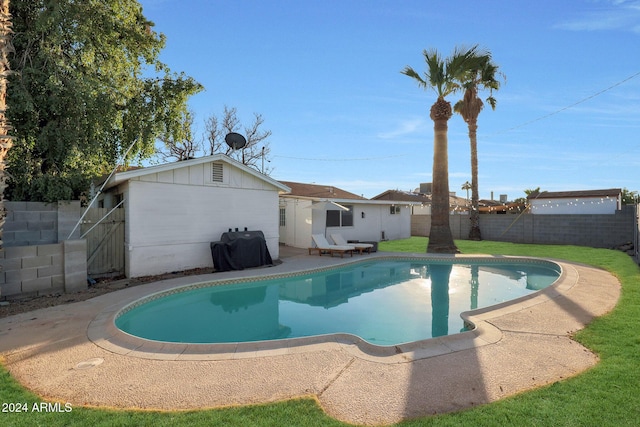 view of pool with a grill