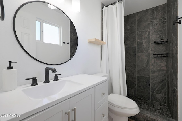 bathroom featuring vanity, toilet, and walk in shower