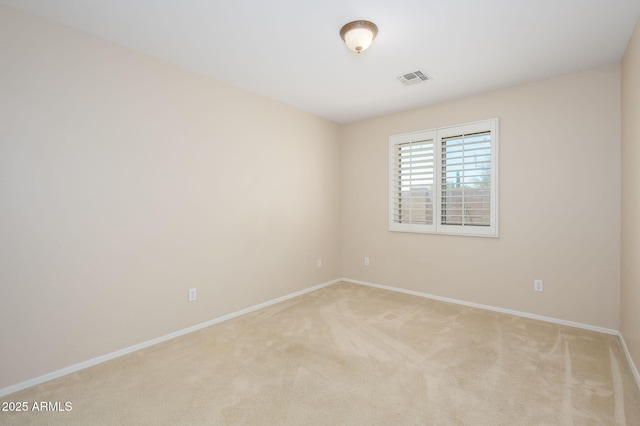 carpeted empty room with baseboards and visible vents