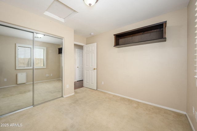 unfurnished bedroom featuring a closet, carpet flooring, and baseboards