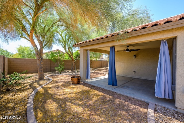 view of yard with a patio, a fenced backyard, and ceiling fan
