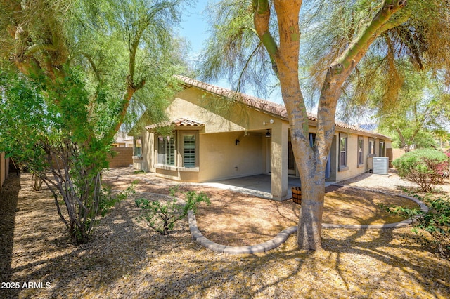 back of property featuring stucco siding, a fenced backyard, cooling unit, a patio area, and a tiled roof